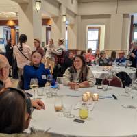 Guests talk at round tables
